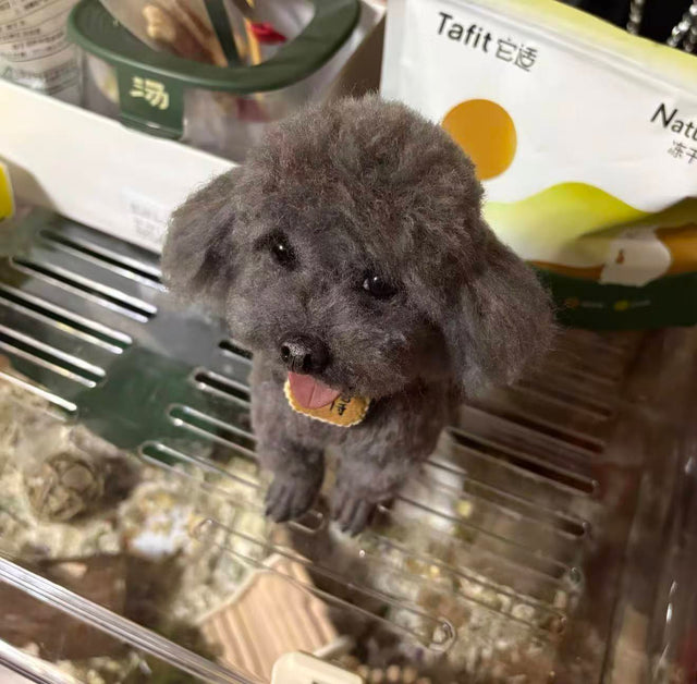 Handmade felted replica of a gray poodle